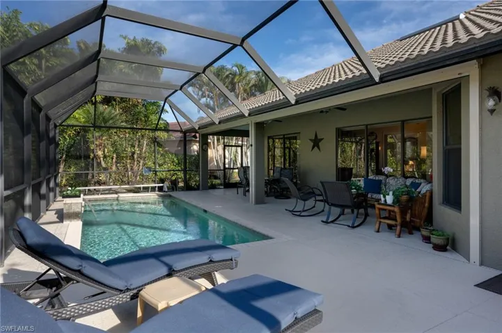Outdoor pool with a sunroom, a lanai, and a patio