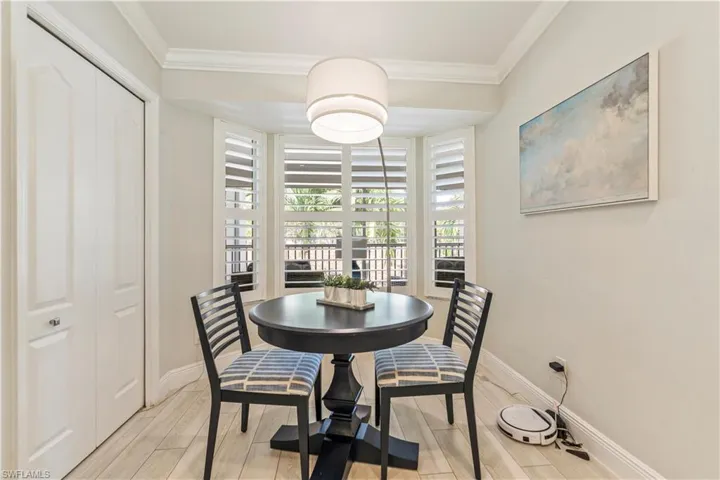 Dining space with baseboards, ornamental molding, and wood tiled floor