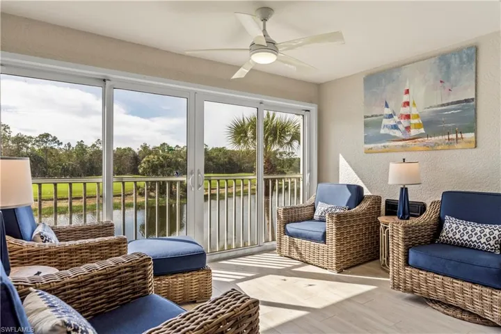 Sunroom featuring a water view and ceiling fan