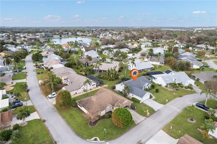 Birds eye view of property with a water view