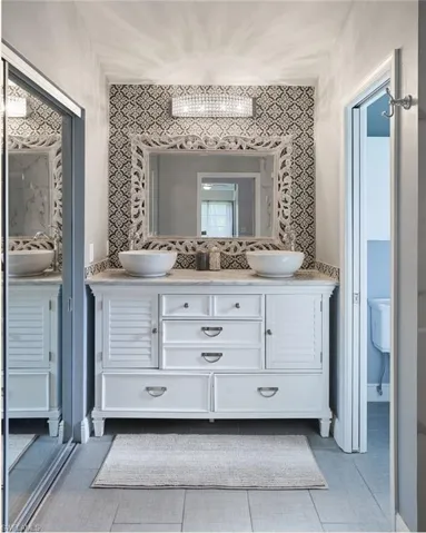 Bathroom with tile patterned floors, vanity, and toilet