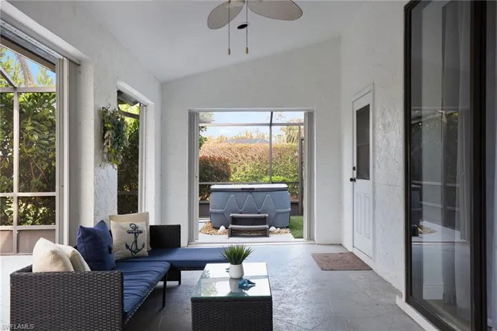 Sunroom featuring a healthy amount of sunlight, ceiling fan, and vaulted ceiling