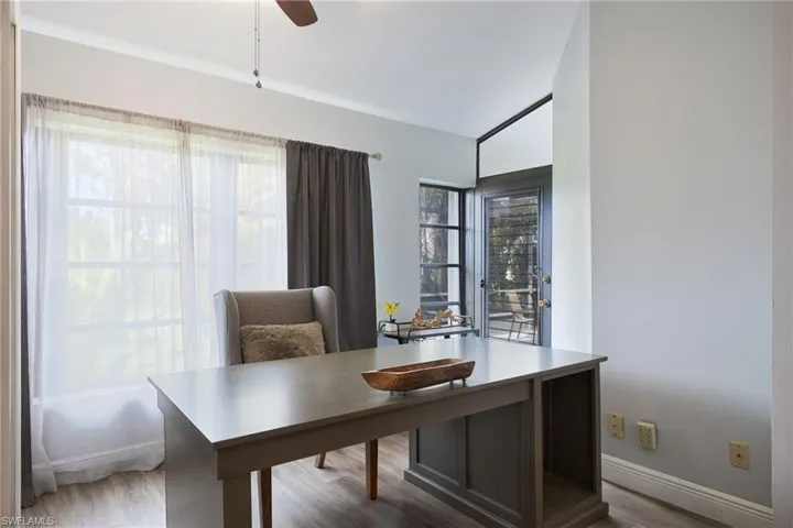 Office space with hardwood / wood-style floors and ceiling fan