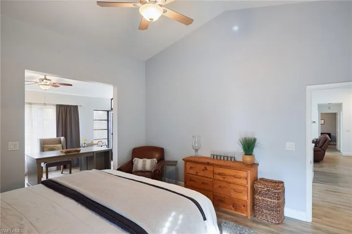 Bedroom featuring lofted ceiling, light hardwood / wood-style floors, and ceiling fan