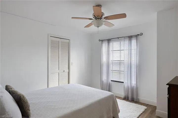 Bedroom featuring a closet, hardwood / wood-style floors, and ceiling fan
