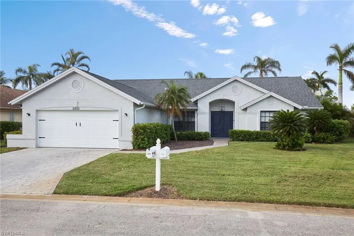 Single story home with a front yard and a garage