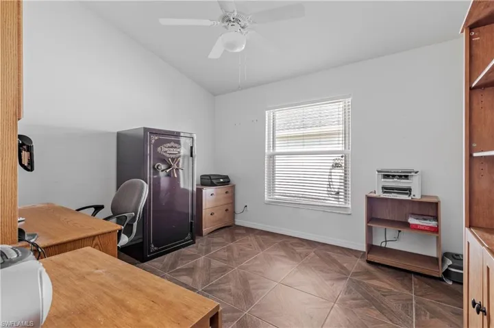 Office area with vaulted ceiling and a ceiling fan