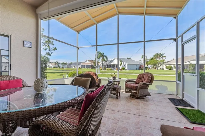Sunroom featuring a residential view and outdoor dining space