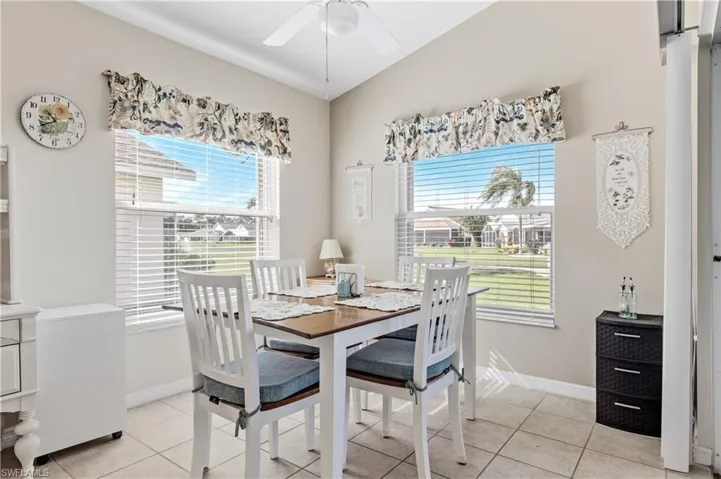 Dining space featuring light tile patterned floors