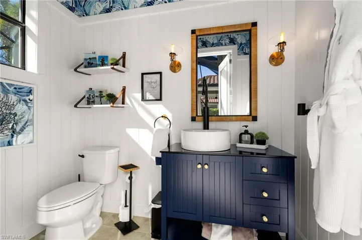 Pool Half bathroom with vanity and tile patterned flooring