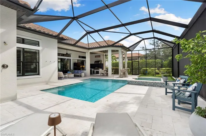 View of swimming pool featuring a patio, a sunroom, a lanai, a pool with connected hot tub, and ceiling fan