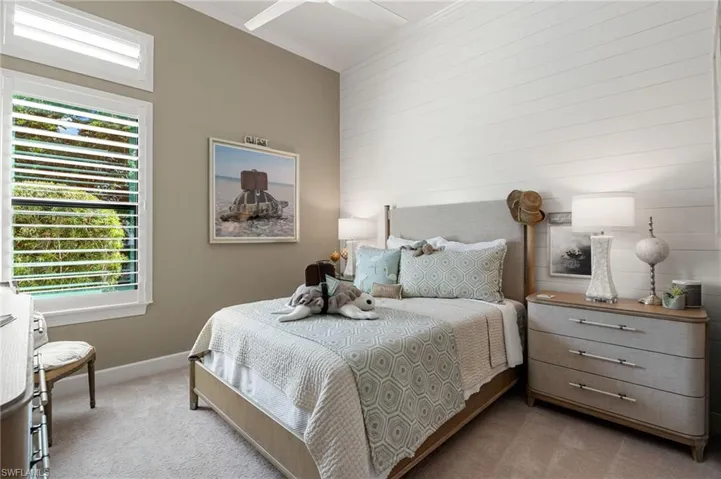 Bedroom featuring light carpet and ornamental molding