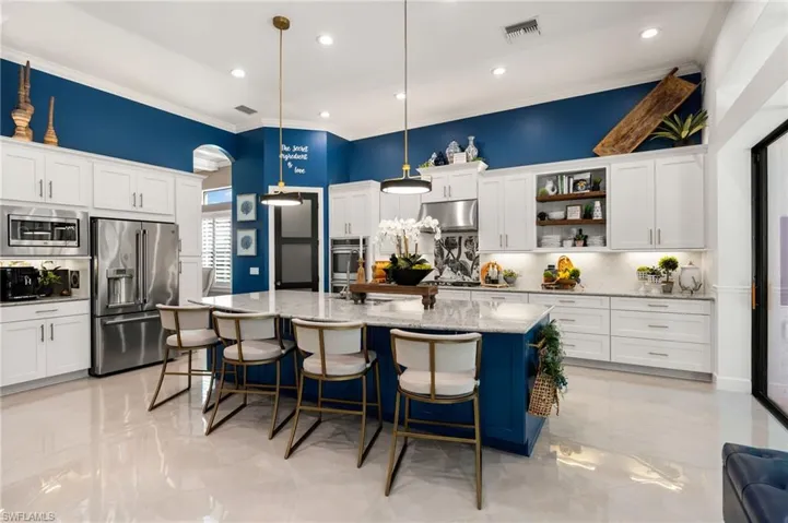 Kitchen featuring tasteful backsplash, crown molding, white cabinetry, open shelves, and stainless steel appliances