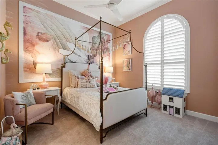 Carpeted bedroom with crown molding and a ceiling fan