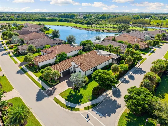 Aerial view of residential area featuring a nearby body of water