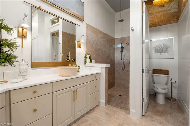 Bathroom with vanity, a walk in shower, and crown molding