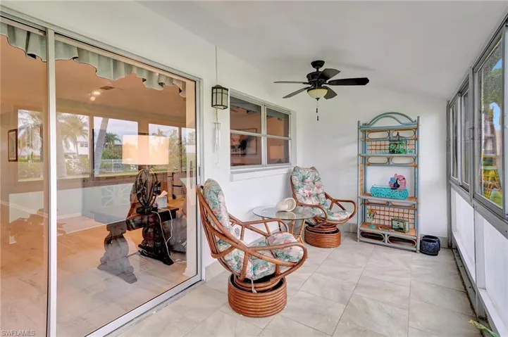 Sunroom featuring plenty of natural light, vaulted ceiling, and ceiling fan