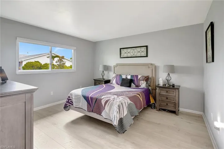 Bedroom featuring light wood-style floors and baseboards
