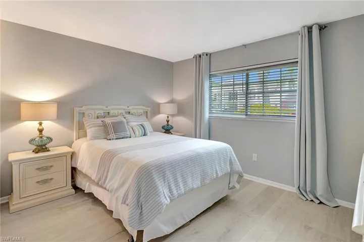 Bedroom with light wood-style flooring and baseboards