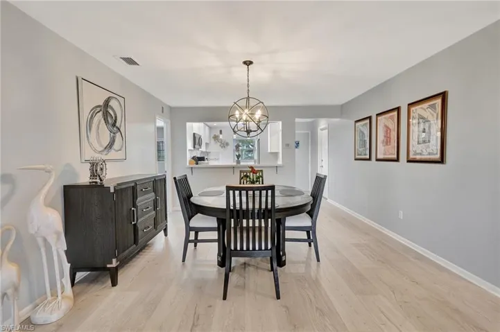 Dining room featuring a chandelier and light wood-style floors