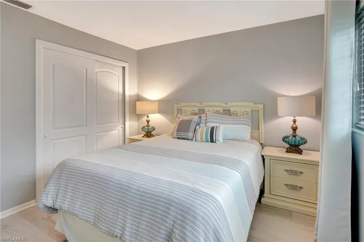 Bedroom featuring light wood-style floors and a closet