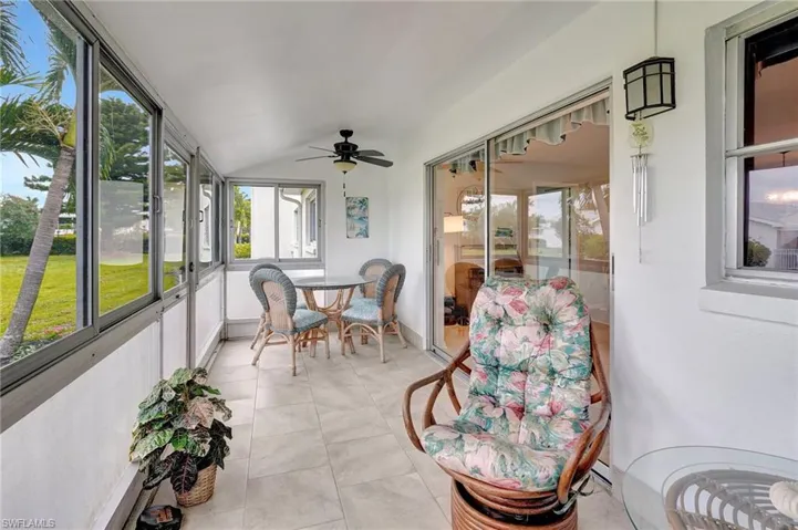Sunroom featuring a ceiling fan and vaulted ceiling
