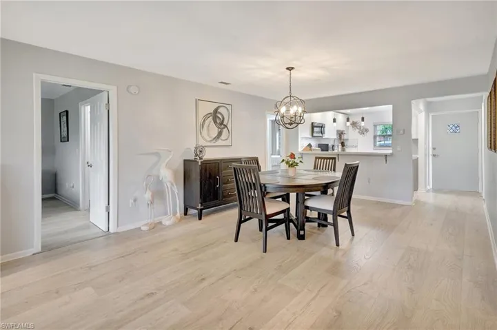 Dining area featuring a chandelier and light wood-type flooring