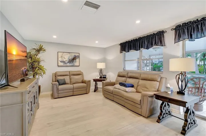 Living room featuring light wood finished floors and recessed lighting