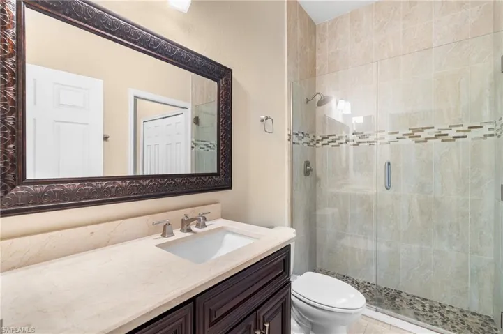 Bathroom with vanity, toilet, and walk in shower