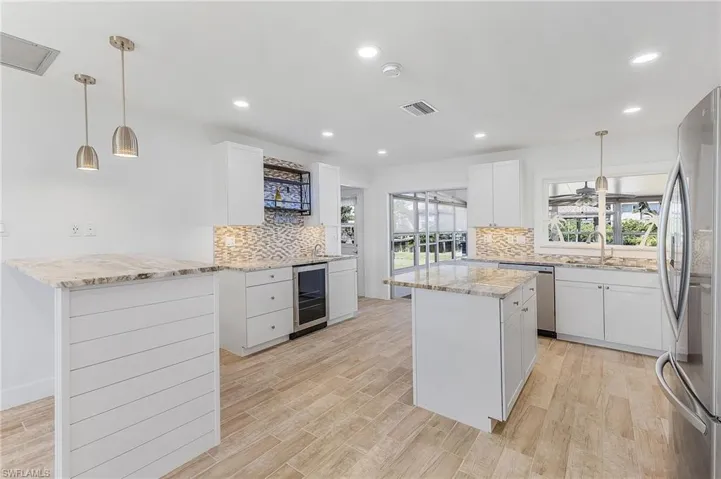 Large kitchen with built-in table, coffee/wine bar, and island.