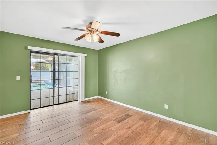 Empty room with light wood finished floors and a ceiling fan