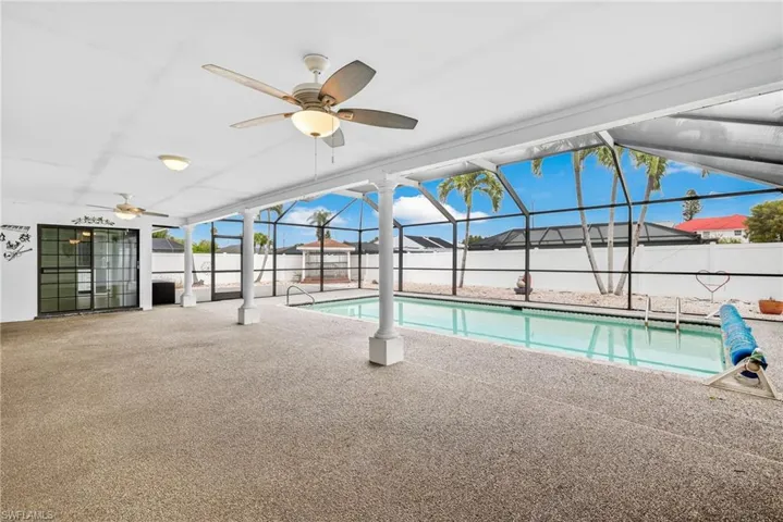 View of swimming pool with a lanai, a patio area, a sunroom, ceiling fan, and a fenced backyard