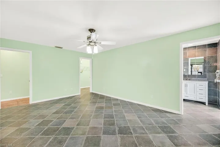 Spare room with baseboards and ceiling fan
