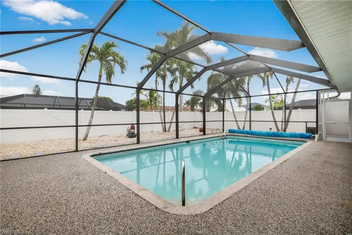 View of swimming pool with glass enclosure, a sunroom, a patio, and a fenced backyard