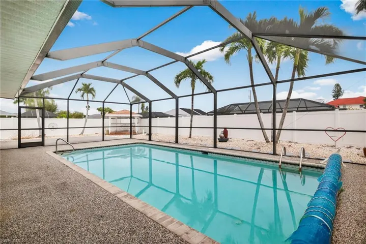View of swimming pool with a lanai, a sunroom, a fenced backyard, and a patio area