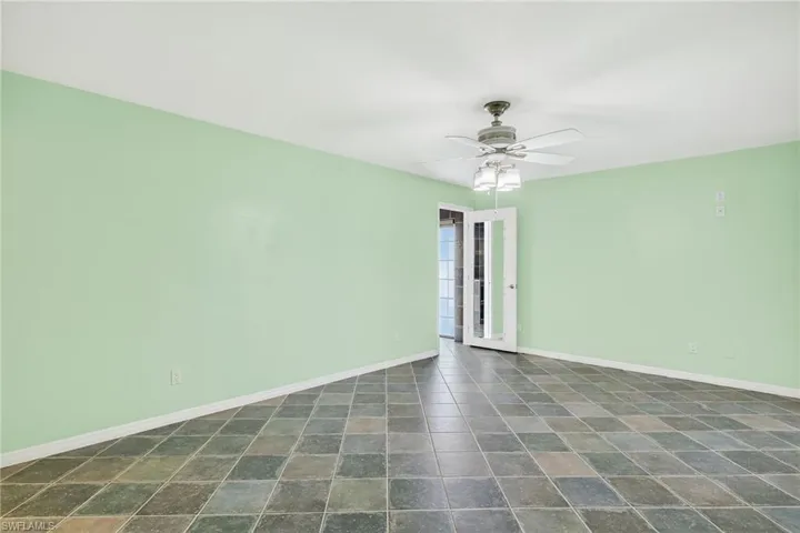 Unfurnished room featuring baseboards and a ceiling fan