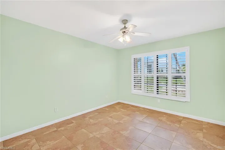 Empty room with baseboards and ceiling fan