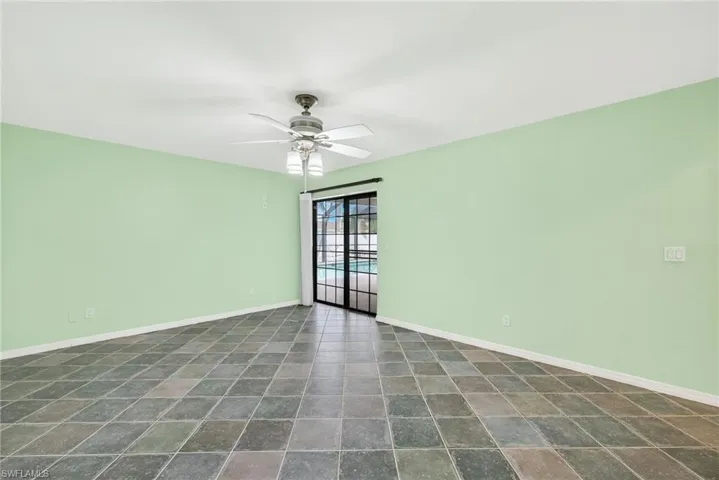 Empty room featuring baseboards and ceiling fan