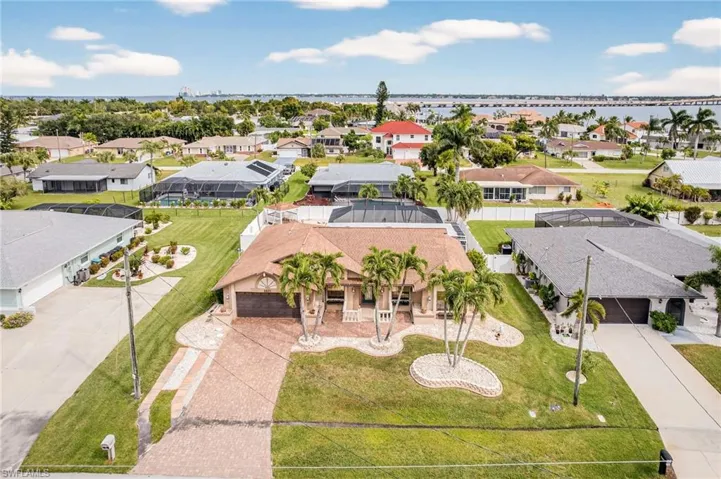Aerial view of residential area featuring a nearby body of water