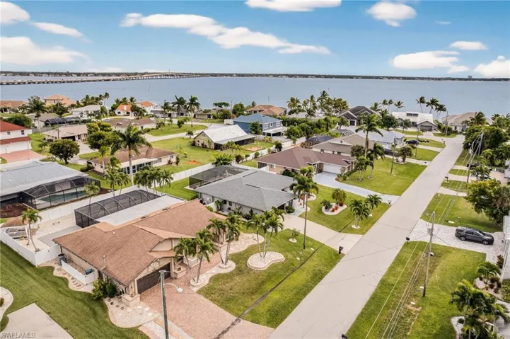 Aerial view of residential area featuring a nearby body of water and a notable bridge