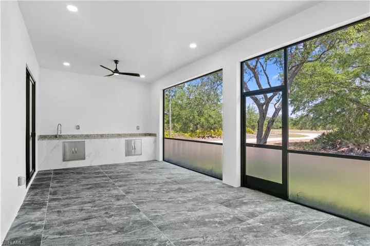 Spare room featuring a ceiling fan, recessed lighting, and marble finish floor