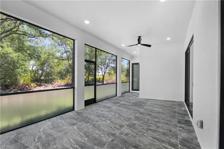 Unfurnished sunroom featuring recessed lighting and marble finish floor