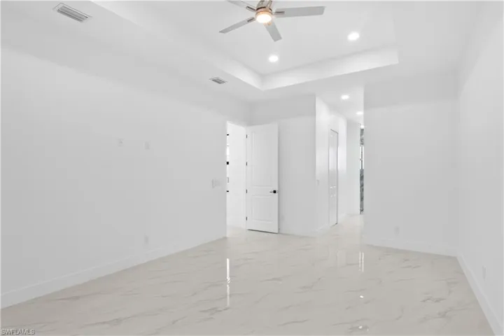 Spare room featuring recessed lighting, ceiling fan, marble finish floor, and visible vents