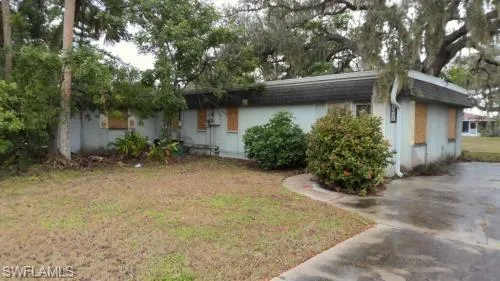 View of front facade with a front yard and stucco siding