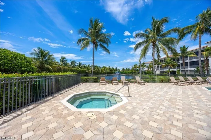 View of swimming pool featuring a patio and a hot tub