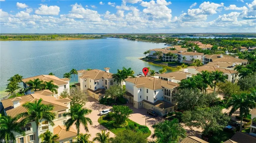 Aerial perspective of suburban area featuring a nearby body of water