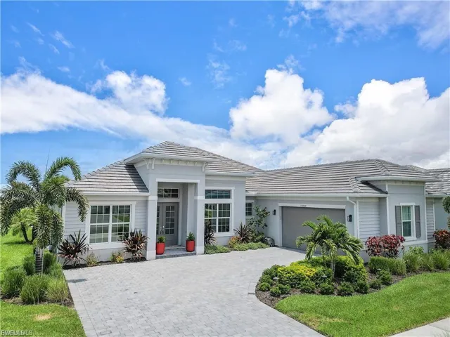 Paved driveway leading to a two-car garage with a textured door