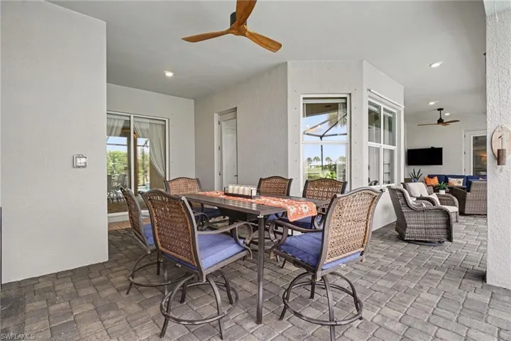 Covered outdoor patio with paver flooring, recessed lighting, and a ceiling fan
