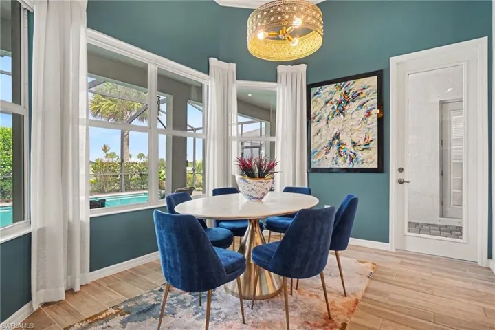Expansive windows, wood-finish flooring, and a decorative ceiling fixture