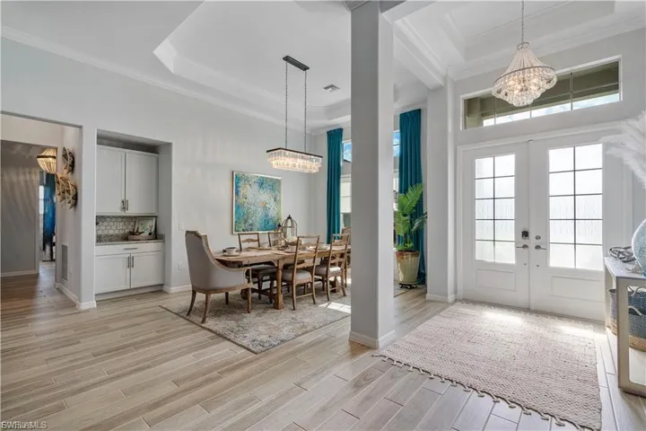 Double entry doors with glass panels and transom window